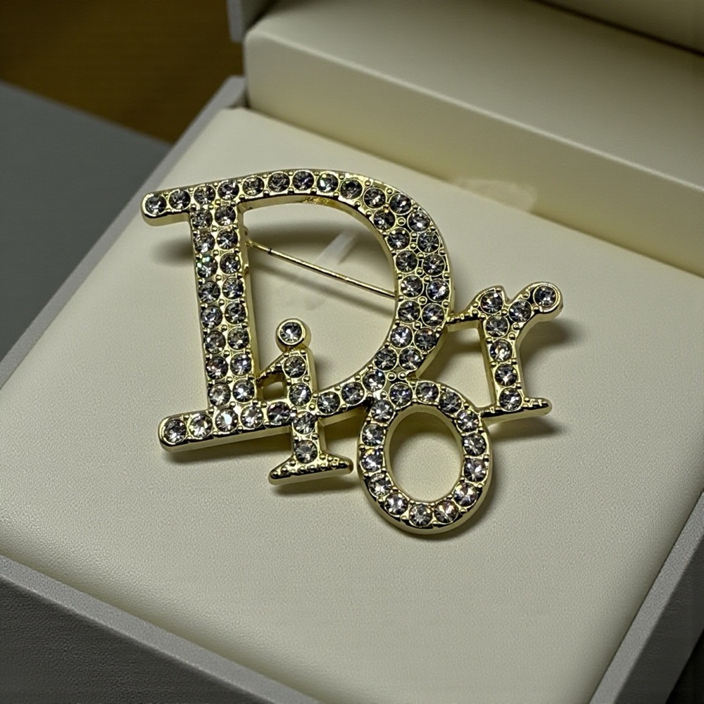 Luxury gold-tone metal letters "D," "i," "o," and "r" clear sparkling crystals